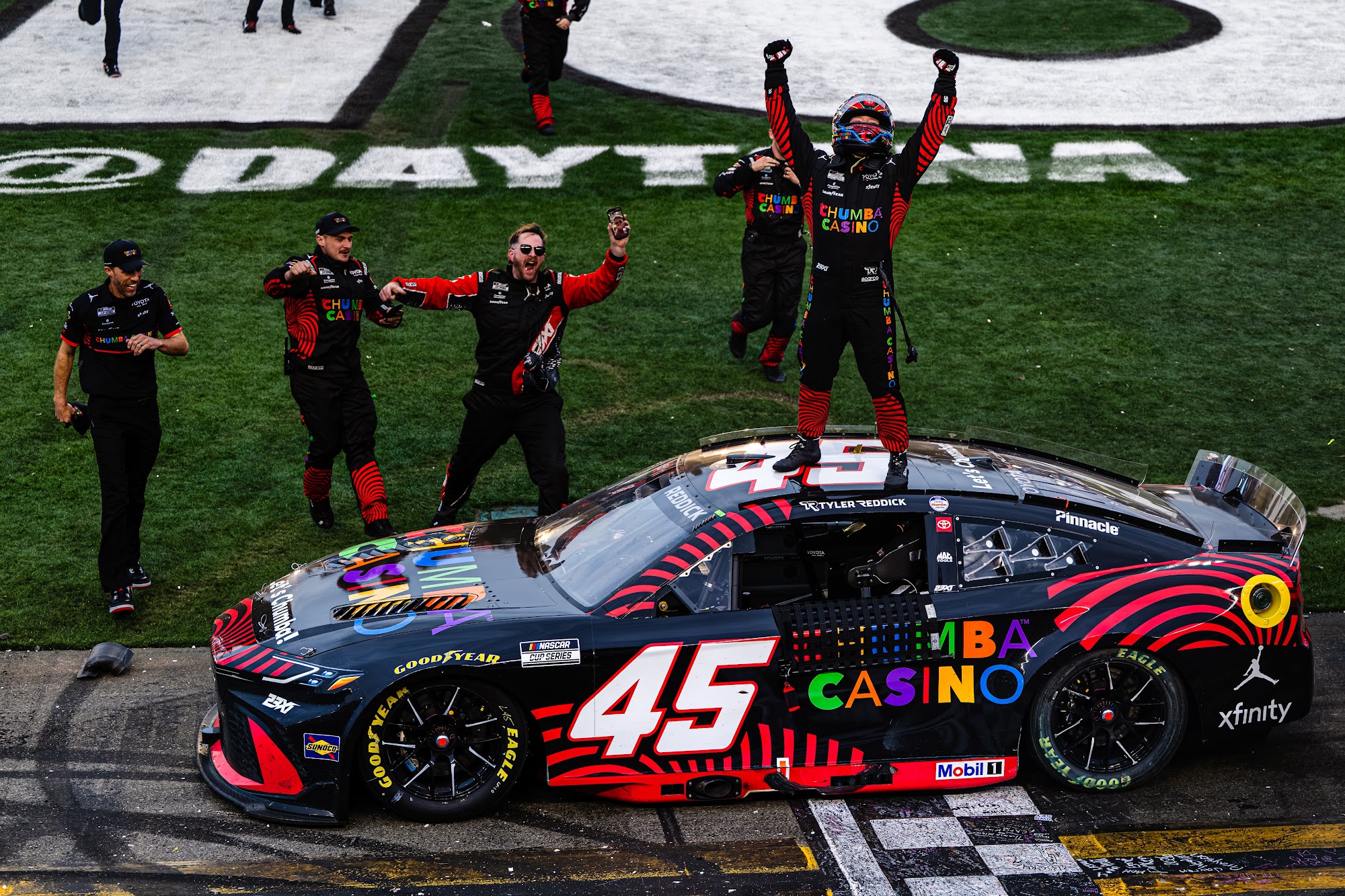 Tyler Reddick celebrates on the roof of the No. 45 after winning the 2026 Daytona 500